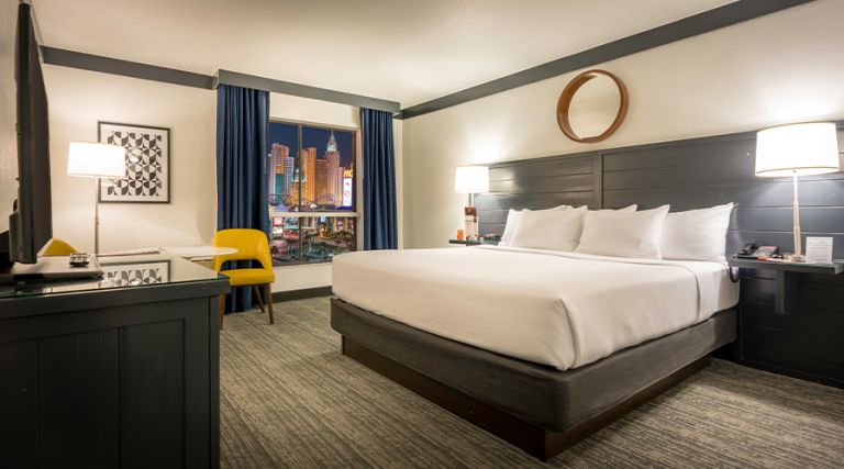 One king bed next to window with Strip view
