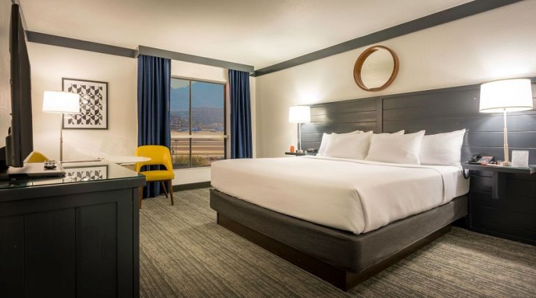 One king bed next to window with airport view.