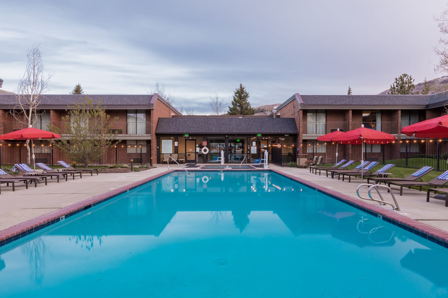 pool with red umbrellas and lounge chairs