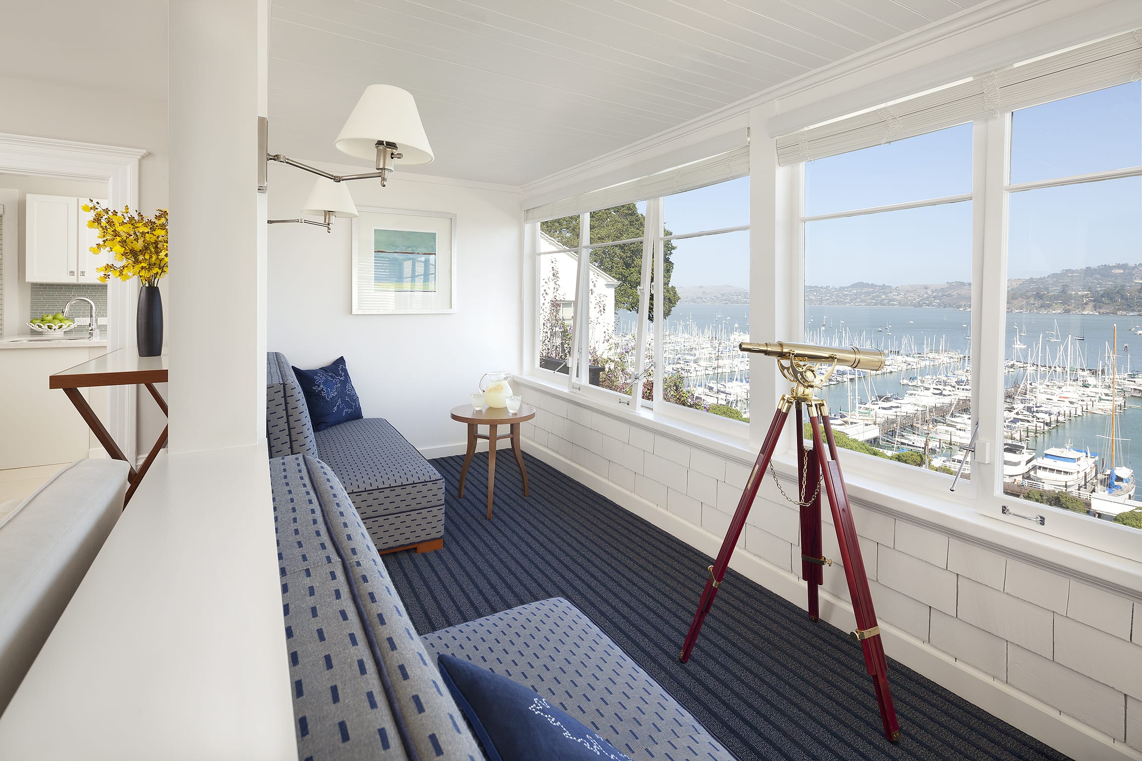 Room 702 sunroom with large windows and telescope