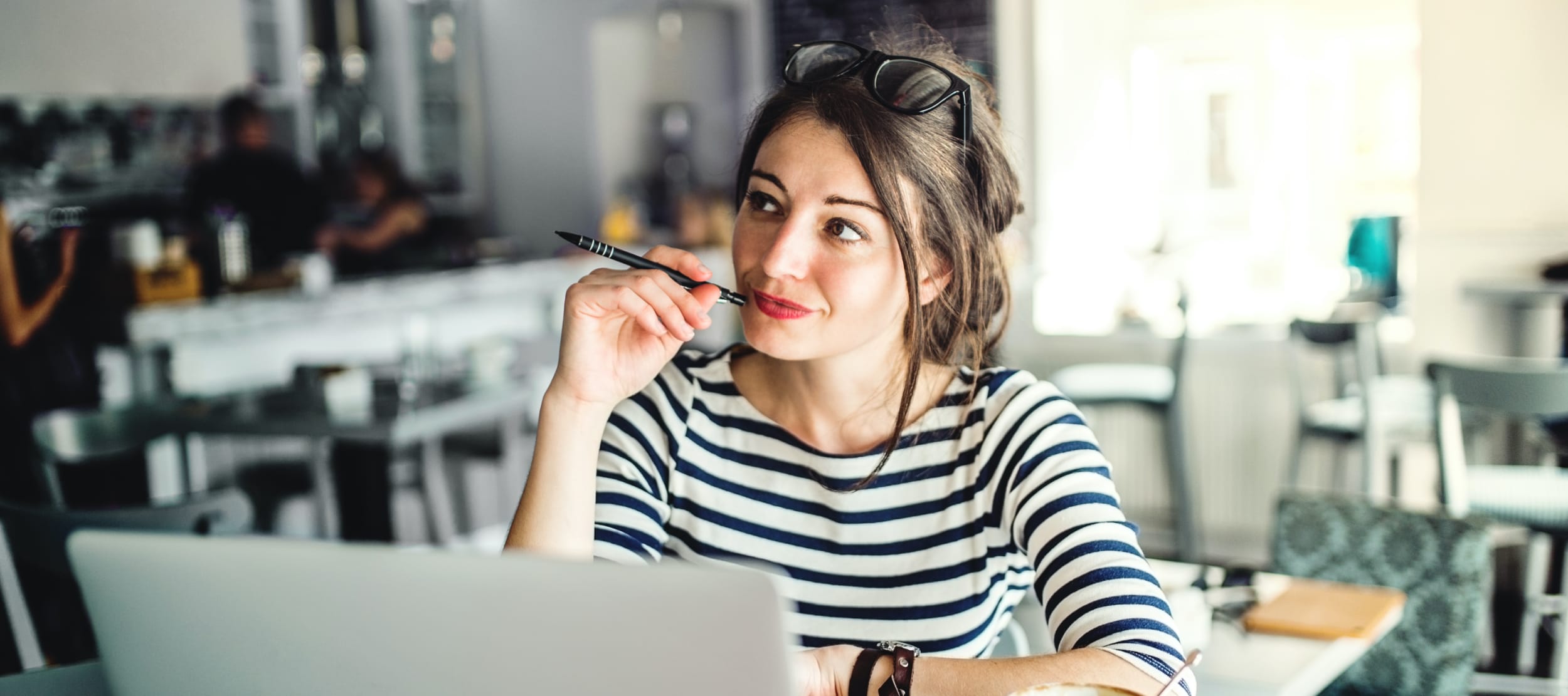 woman-sitting-at-coffee-shop-thinking