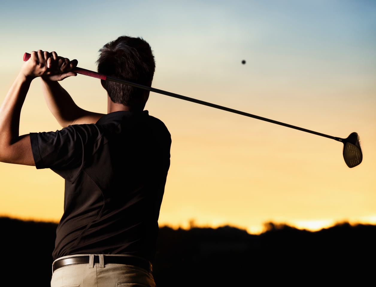 man-golfing-night