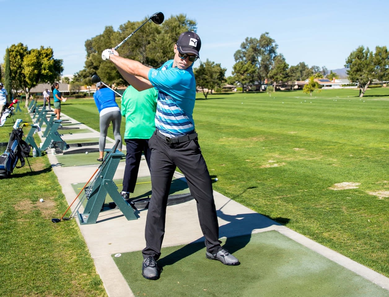man-swinging-golf-club