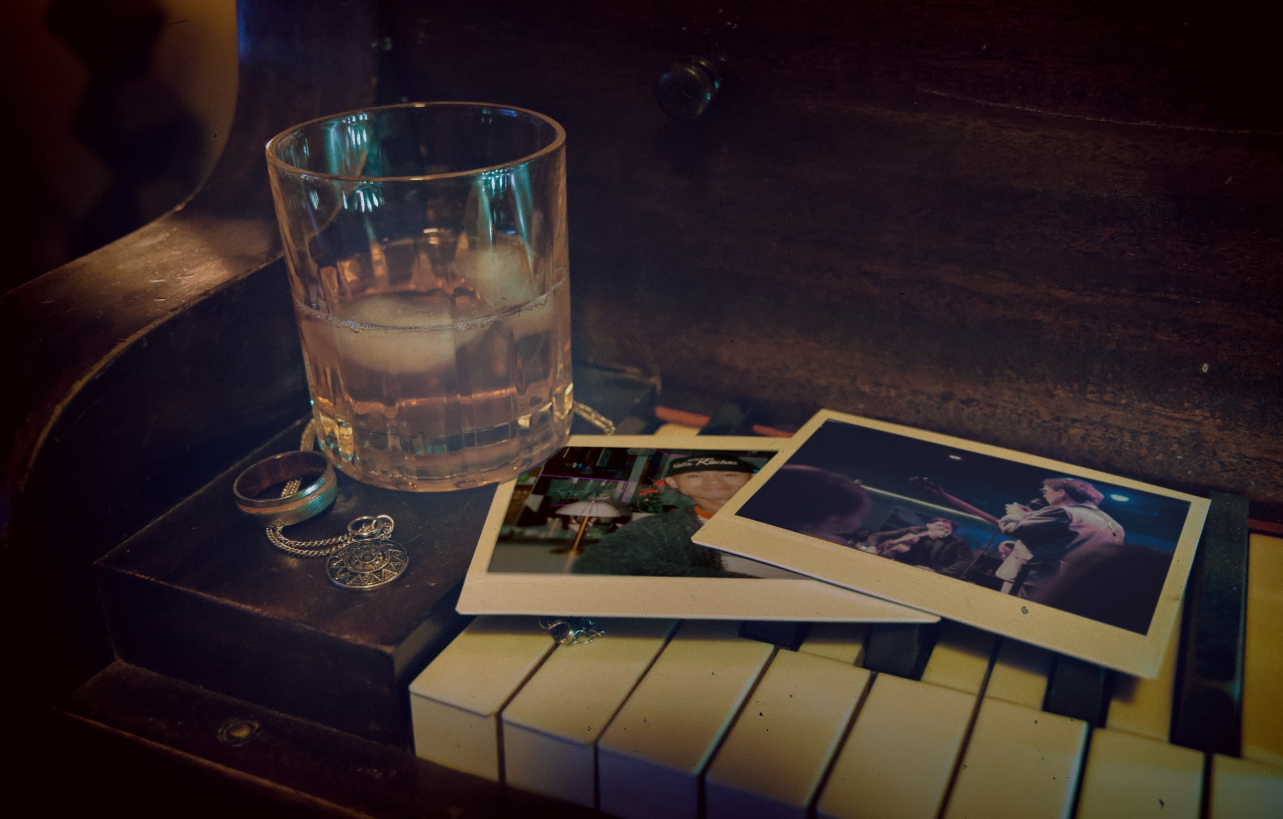Piano with a cocktail and photographs