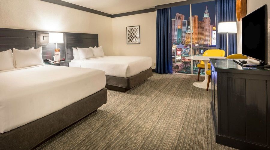 Two bed bed next to window with Strip view