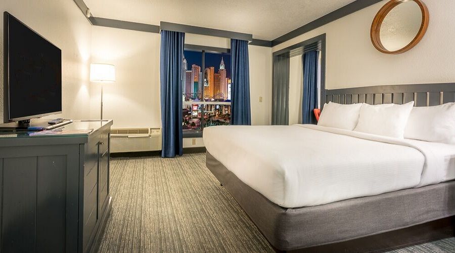 One king bed next to window with Strip view