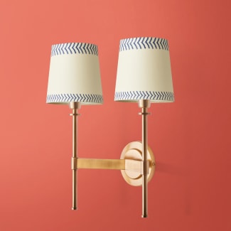 Double Tremmers wall fixture in antiqued brass