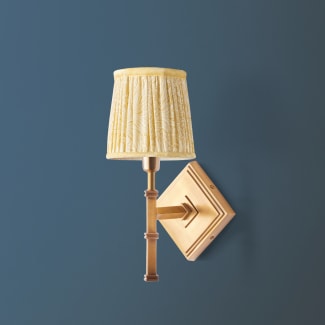 Single Astor wall fixture in antiqued brass