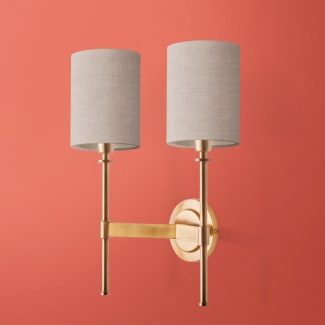 Double Tremmers wall fixture in antiqued brass