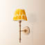 Wrappling wall fixture in antiqued brass