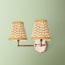 Double insignia wall fixture in antiqued brass