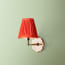 single insignia wall fixture in antiqued brass
