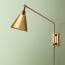 Carter Wall fixture in antiqued Brass