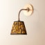 Colombari wall fixture in antiqued brass and cane