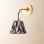 Colombari wall fixture in antiqued brass and cane