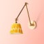 Stork wall fixture in antiqued brass