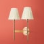 Double Tremmers wall fixture in antiqued brass