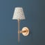 Tremmers wall fixture in antiqued brass