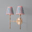 Larger Double chukka wall fixture in antiqued brass