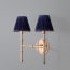 Larger Double chukka wall fixture in antiqued brass
