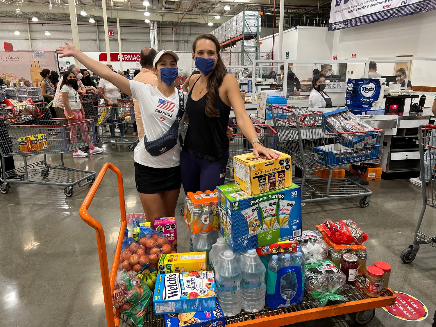 Michelle De La Rosa and Hollie Scott at Costco buying supplies for the trip.