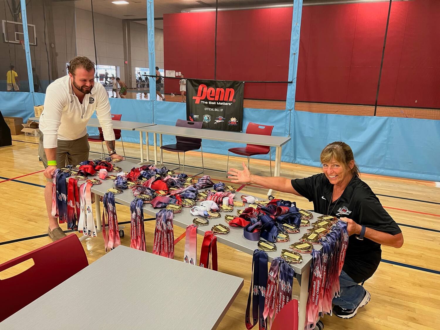 Connor Shane and Debbie Wedeal showing the medals the juniors will receive.