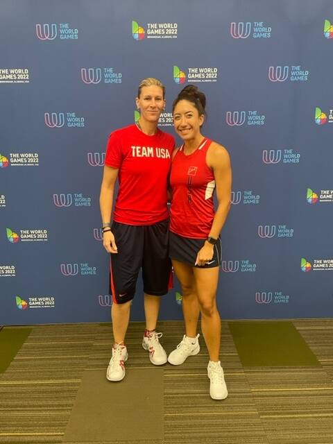 Rhonda Rajsich and Kelani Lawrence in front of the World Games step and repeat