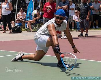 Jose Diaz hitting a racquetball.