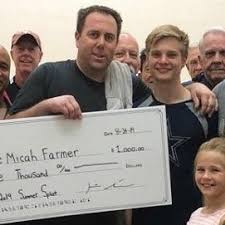 Kevin Sendrey presents check to Micah Farmer