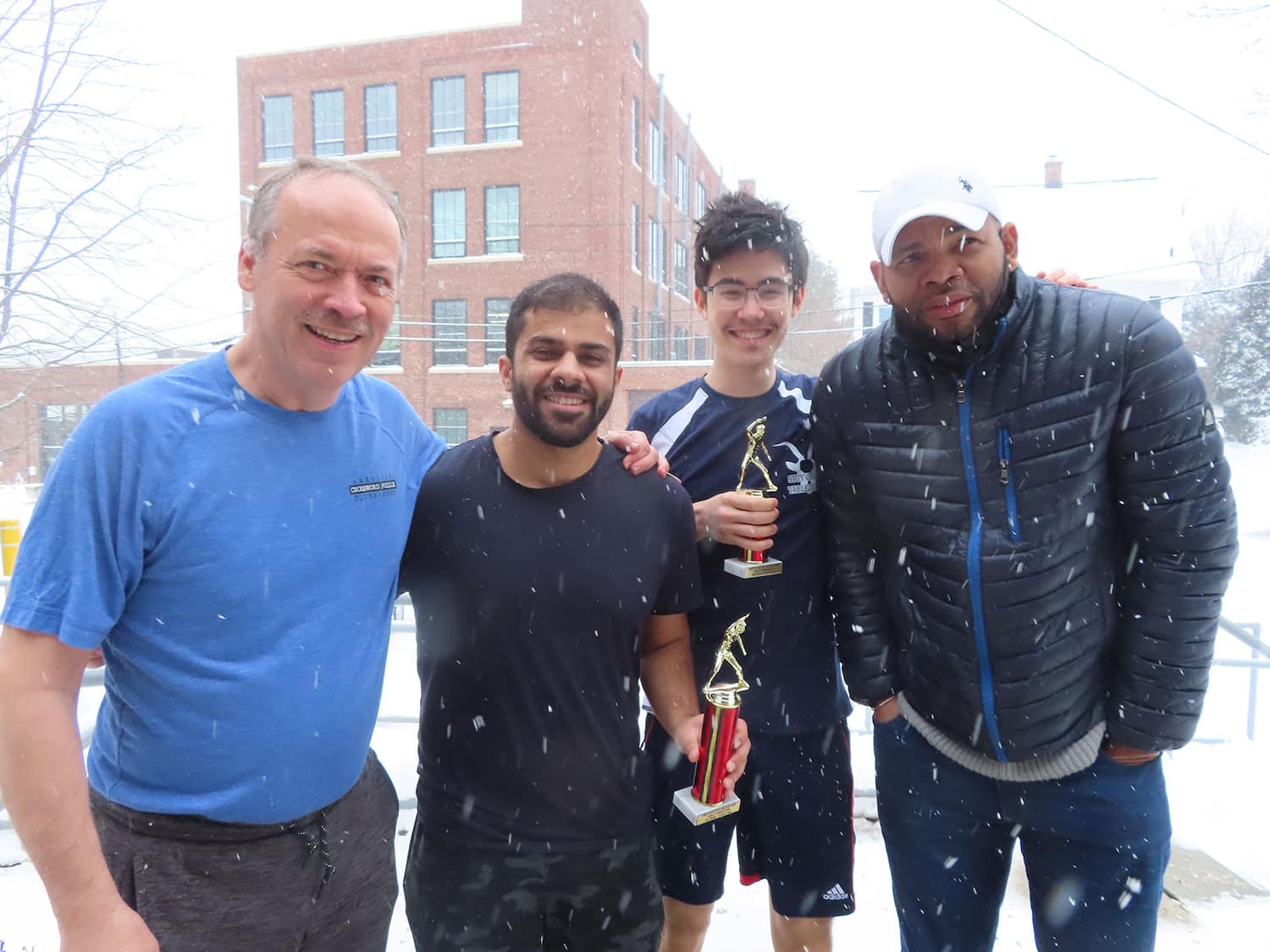 Snow limited attendance at the January Westchester Open. From left to right: Will Shortz (club owner), Shehroze Aamer (winner, U1600), Cyrus Cursetjee (runner-up, U1600), Robert Roberts (club manager)