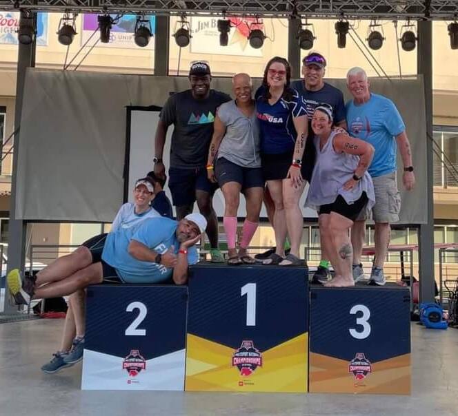 Leslie Battle stands on top of an Athena podium