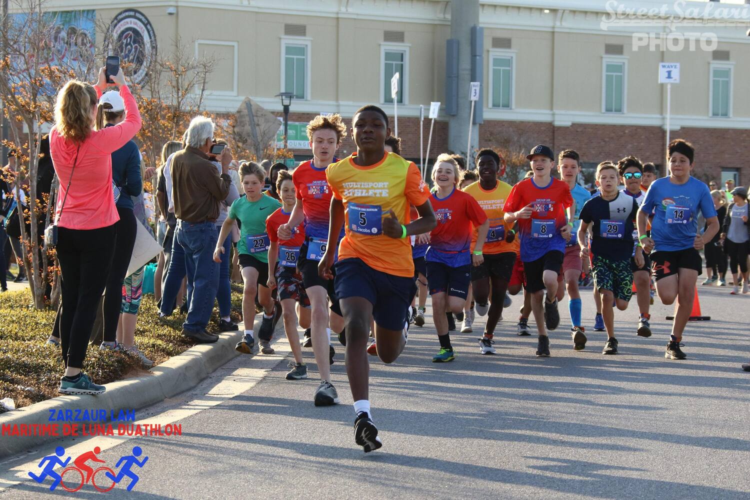 a child runs ahead of the pack at the maritime de luna duathlon youth event