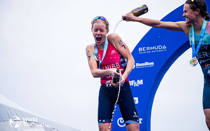 Taylor Knibb gets champagne poured on her on the WTCS Bermuda podium