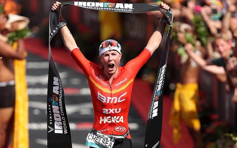 Chelsea Sodaro takes the tape as the winner of the 2022 Ironman World Championship in Kona