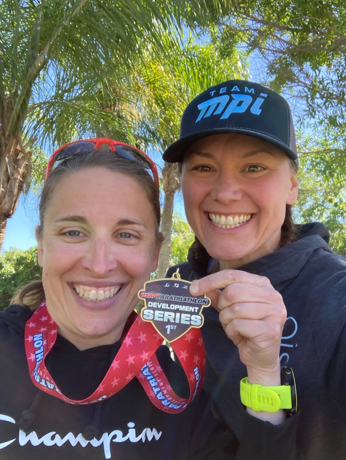 Deb Chucoski and her guide Ericka holding a medal together