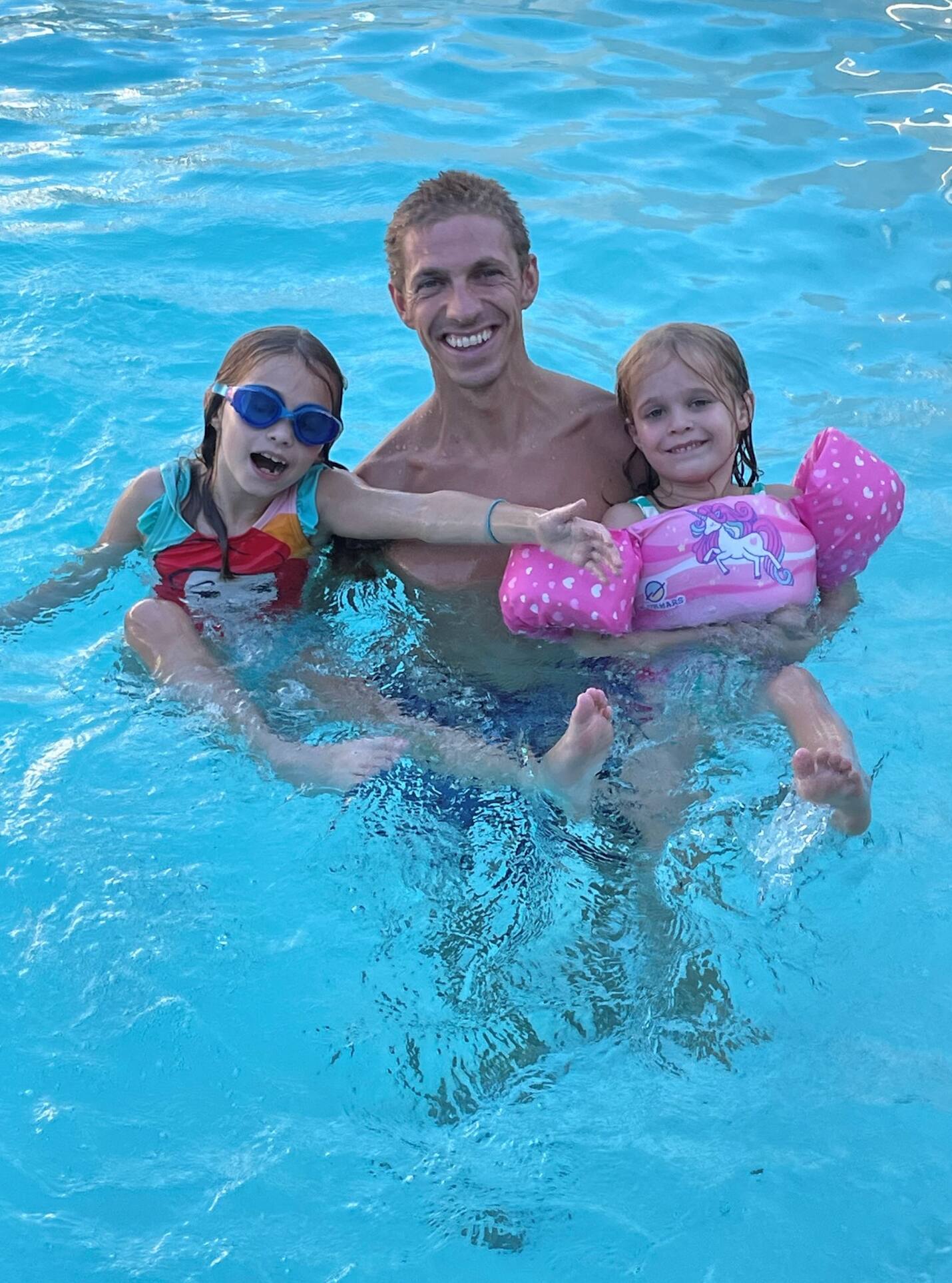 Chris Hammer poses with his two daughters in a pool