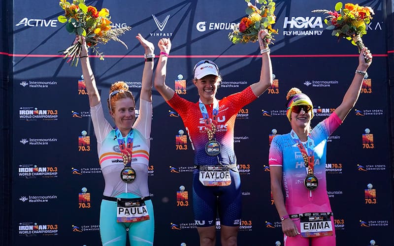 Taylor Knibb stands on top of the IRONMAN 70.3 World Championship podium