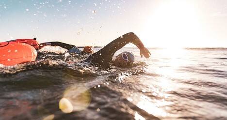 Athletes swimming in open water