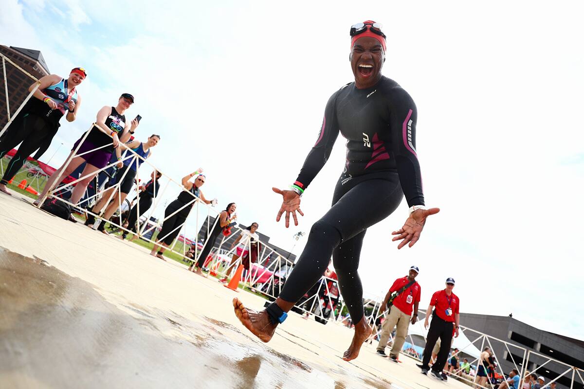 An athlete is excited right before entering the water an an open water swim race at the 2022 Multisport National Championships Festival.