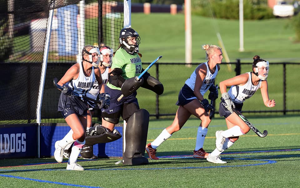 Moravian runs out of the goal to defend a penalty corner