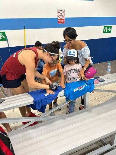 Erika Manilla Signing a Team USA shirt for Sebastian and Valentina Cardona from Honduras at the 2023 Pan American Championships