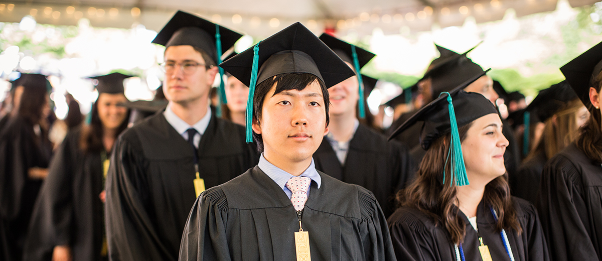 student standing at a graduation ceremony