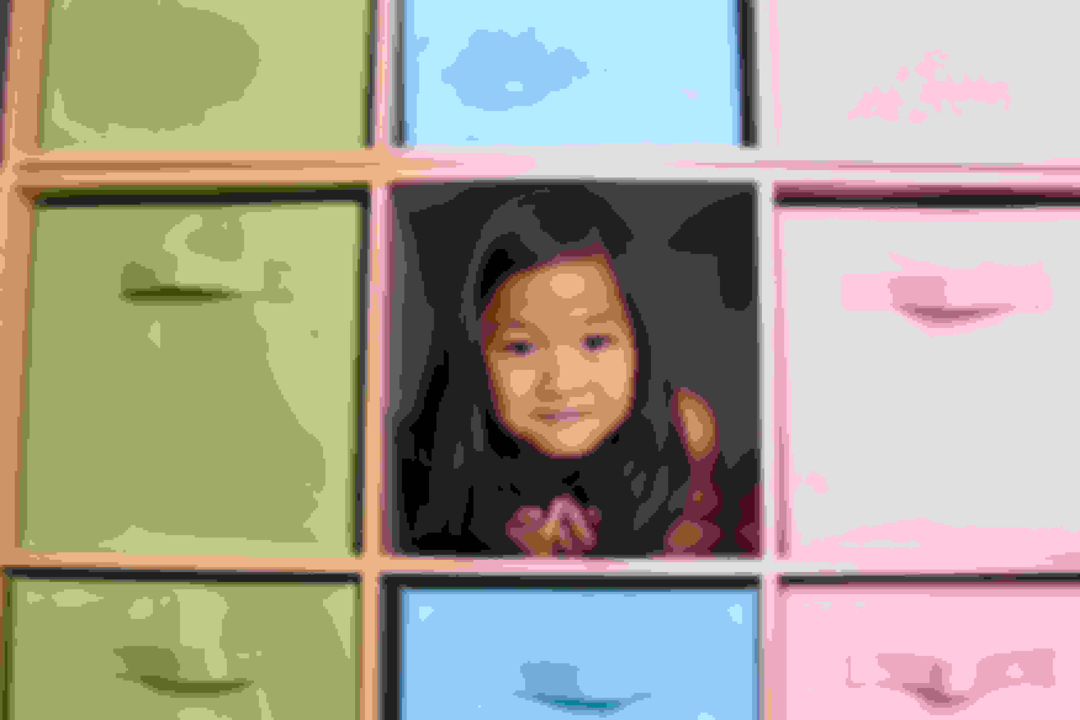 Girl smiling among storage cubbies