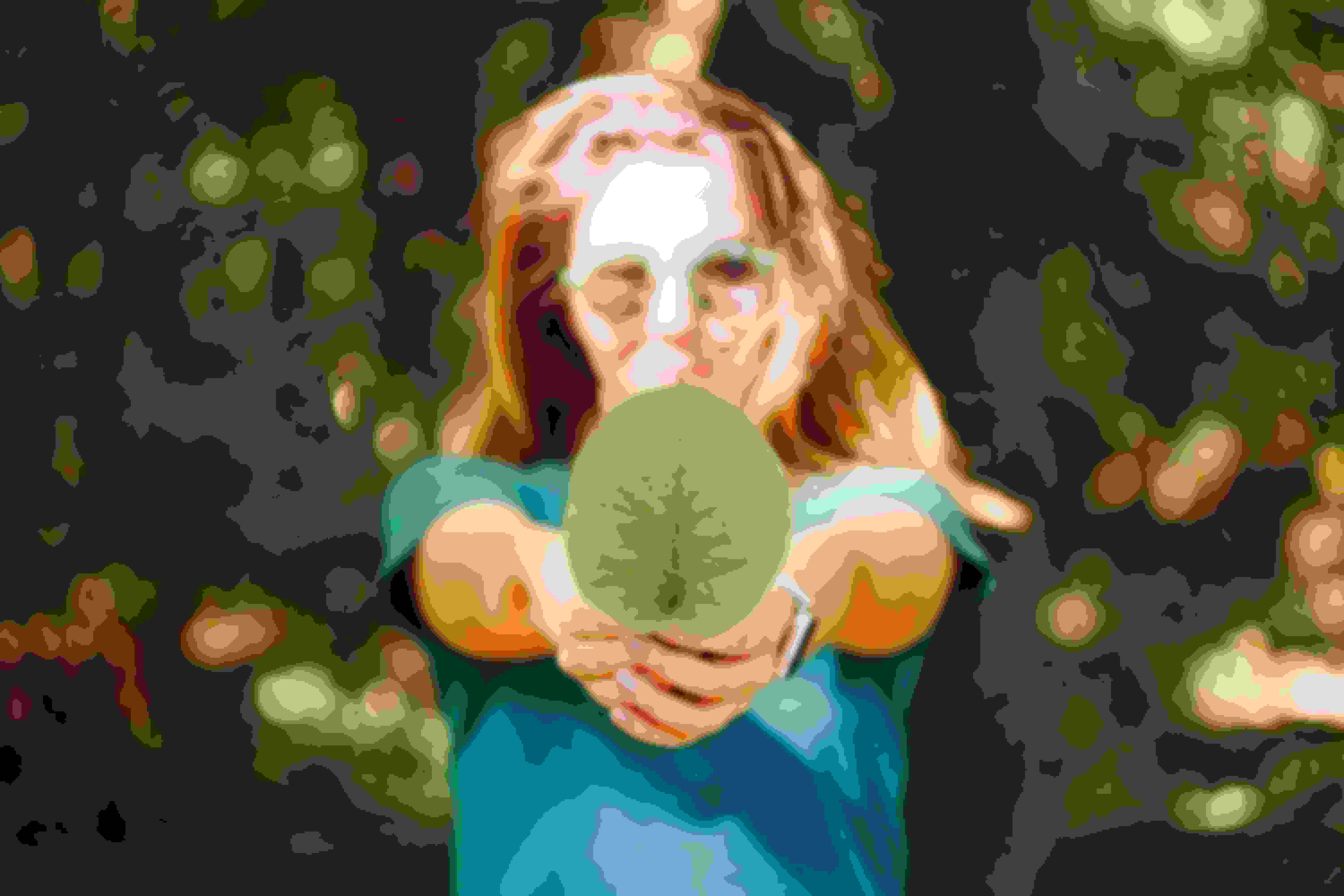 Woman holding a large leaf