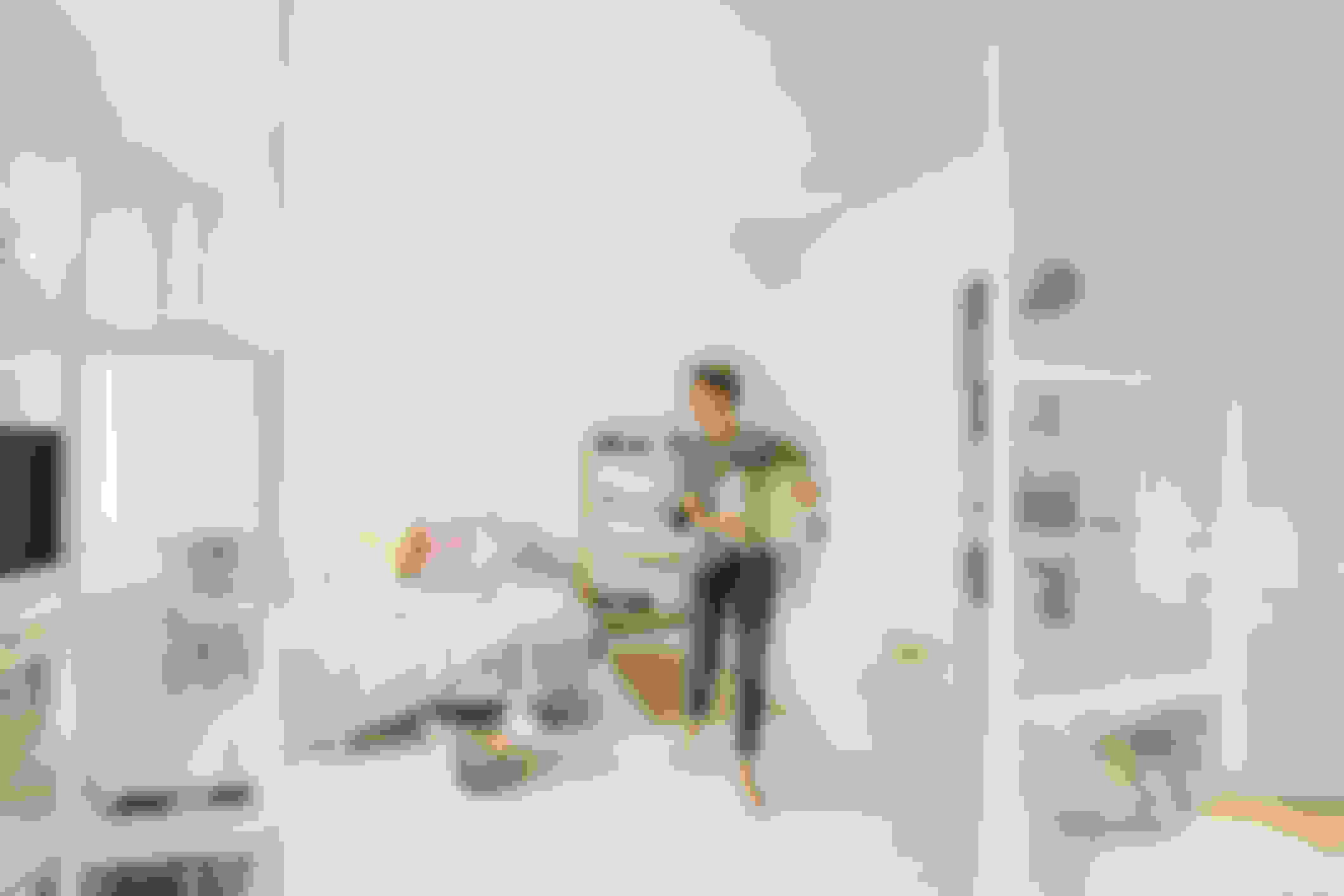 person moving around plant in a bedroom