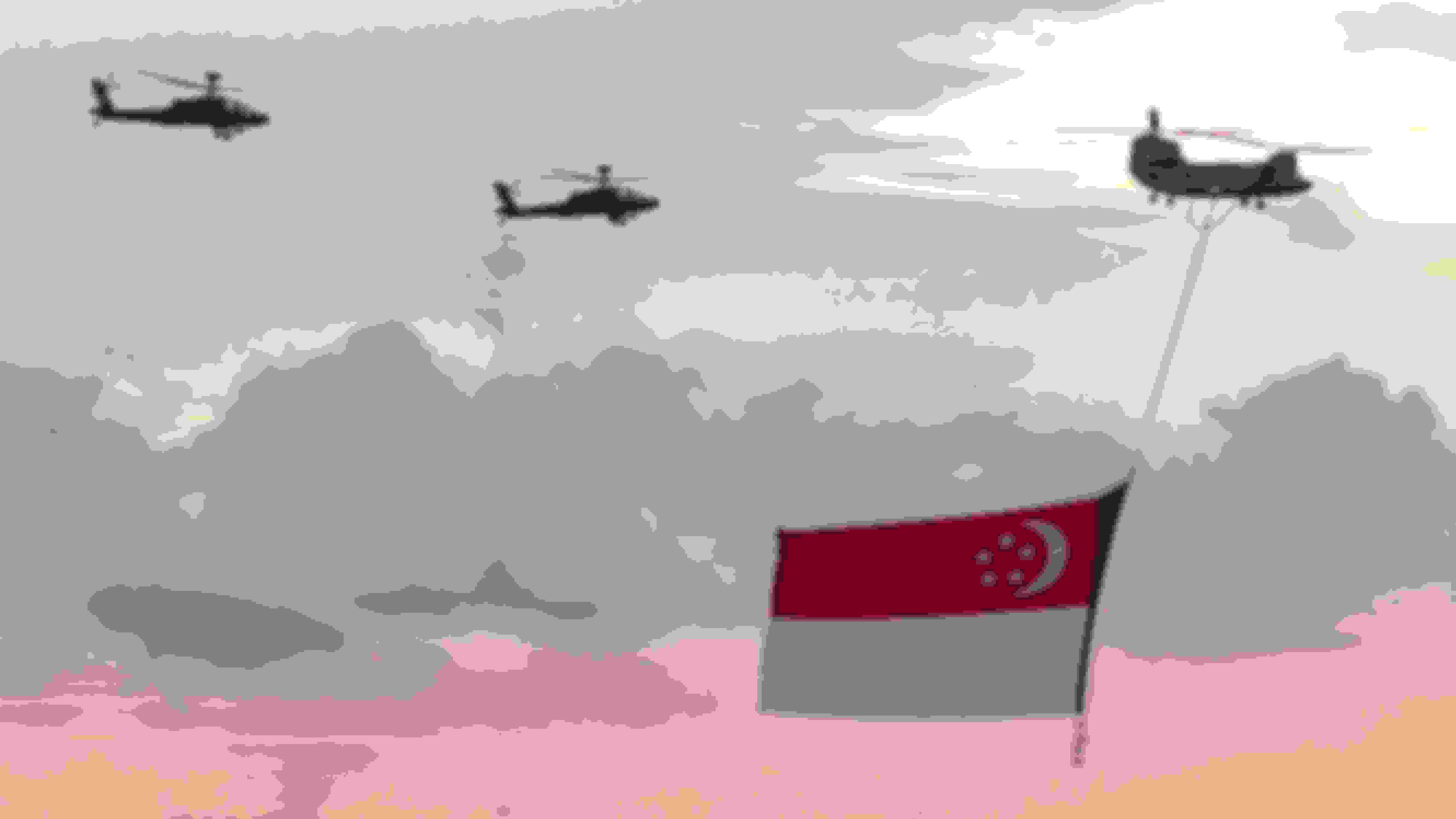 three helicopters holding up a Singapore flag