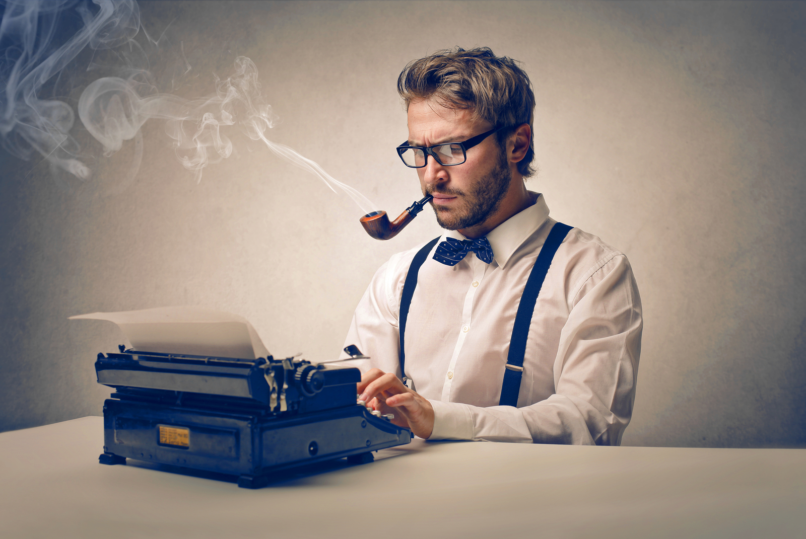 handsome journalist writing with typewriter