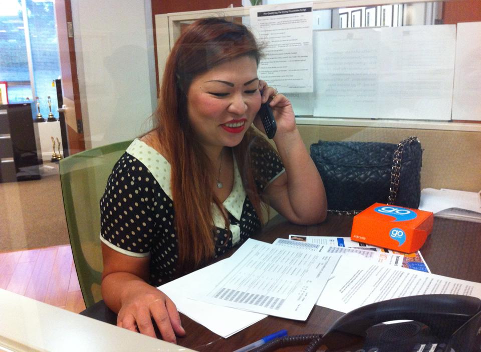 Woman using a disposable AT&T Go Phone at Century 21 Masters telemarketing center in Walnut.