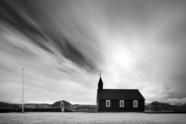 Budir Church, Snaefellsness Peninsula, Iceland. Visiting this iconic location in Iceland I noticed the clouds had left a pattern around the church spire. I composed this image to present the scene as if a beam was coming out of the church. Canon 5D Mark II converted to 720nm infrared, Canon TS-E 17mm f/4L, 1/30 sec @ f8, ISO 100, tripod. Monochrome conversion and curves adjustments in Photoshop CC.