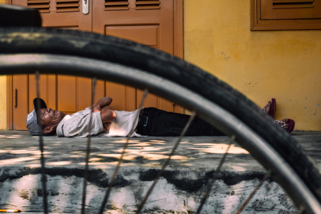 Rickshaw driver asleep in Hoi An, Vietnam. The silent shutter of the Fujifilm X100S meant I could shoot from close range without waking him. It could meant I could move around freely, kneeling down to capture this perspective. Fujifilm X100S, fixed 35mm f/2 @ 35mm, 1/160s @ f7.1, 200 ISO, handheld. Contrast, curves and saturation adjustment in Adobe Photoshop CC.